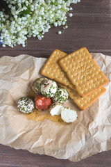 Labne balls with herbs and spices on craft paper. Traditional yogurt cream cheese in the Middle East. Vegetarian food.