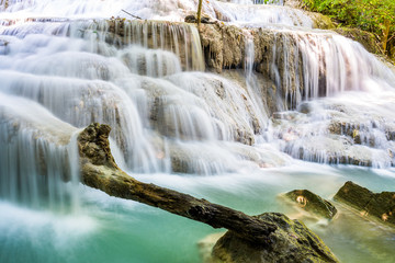 Obraz premium Waterfall and blue emerald water color in Erawan national park. Erawan Waterfall tier, Beautiful nature rock waterfall steps in tropical rainforest at Kanchanaburi province, Thailand