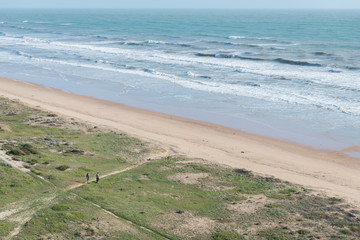 
walk on the beach of huelva keeping the safety distance