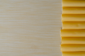 Uncooked cannelloni on beige.