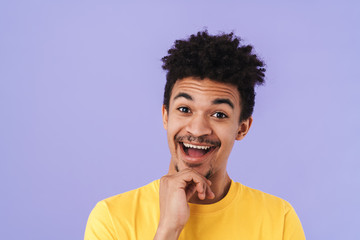 Photo of excited african american man smiling and looking upward