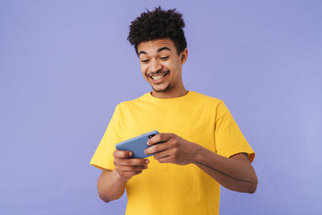 Photo of african american man playing video game on smartphone