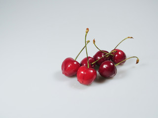 some fresh berries of a cherry lie on a table