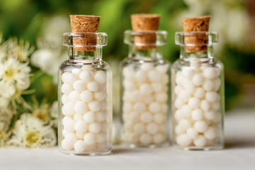 Homeopathy globules in bottles. homeopathy, naturopathy and alternative medicine. Alternative homeopathy medicine concept. - obrazy, fototapety, plakaty