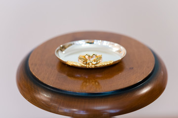simple gold wedding rings on a silver plate