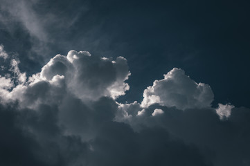 Large white cumulus clouds against a blue sky
