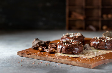 Chocolate donuts with chocolate glaze, nuts. National Donut Day. Homemade baking.