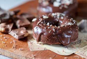 Chocolate donuts with chocolate glaze, nuts. National Donut Day. Homemade baking.