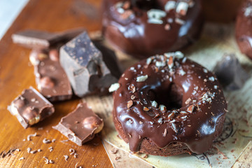 Chocolate donuts with chocolate glaze, nuts. National Donut Day. Homemade baking.