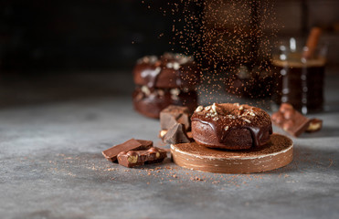 Chocolate donuts with chocolate glaze, nuts and coffee. National Donut Day. Homemade baking.