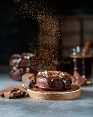 Chocolate donuts with chocolate glaze, nuts and coffee. National Donut Day. Homemade baking.