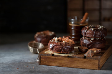 Chocolate donuts with chocolate glaze, nuts and coffee. National Donut Day. Homemade baking.