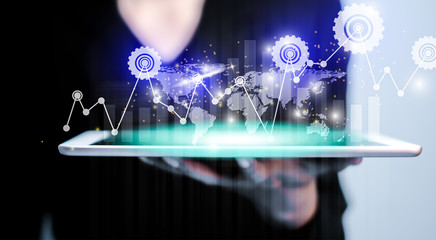 Businesswomen holding tablet for analysis of industrynumerical data and stock market communication with businesses worldwide. Analyzing business industry with financial data graph.