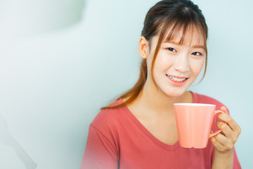 Young Asian woman drink coffee in the morning