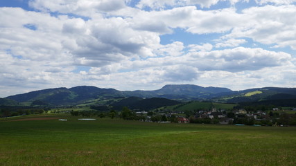 Fototapeta na wymiar Field and mountains, beautiful landscape in Austria in a village.