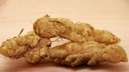Fresh organic ginger at fresh market on wooden background