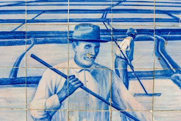 azulejos panels on the facade of the old railways station describing the salt marshes in Aveiro,...