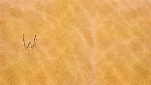 Handwritten animated text in the sand, day of the week-Wednesday.

