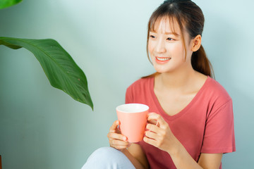Young Asian woman drink coffee in the morning