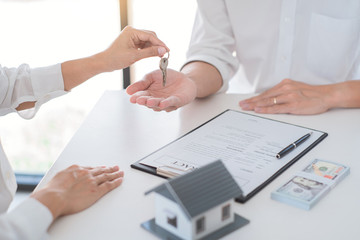 Real Estate concept, Agent with calculator for present price for loan house for investment documents and calculating table payment to customer.