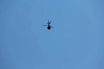 Fototapeta na wymiar helicopter in bright blue sky