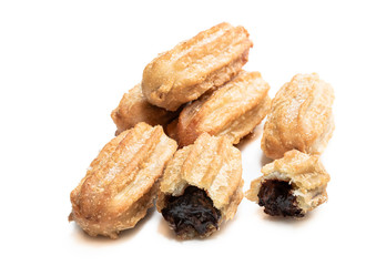 Homemade baked mini chocolate filled churros isolated on white