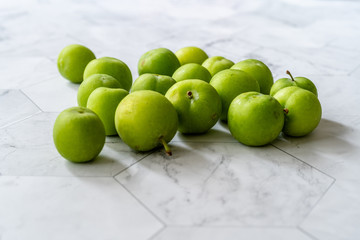 Raw Organic Sour Green Plums Ready to Eat.