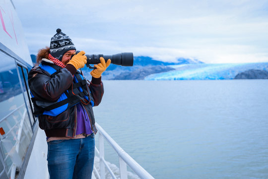 Glacier Gray, Chile - March 09, 2020: Man Tourist with the Photo Camera on the Boat to Glacier Gray 