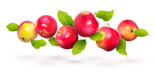 Red apples with green leaves fly on a white background. Background with apples. Natural fresh product