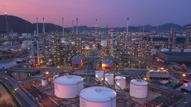 Aerial view. Oil refinery factory and oil storage tank at twilight and night. 