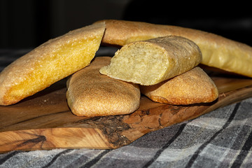 Baked golden bread loaf on a wooden chopping board