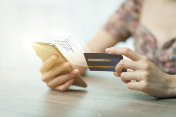 Online shopping concept : woman hands holding cradit card and using credit card online shopping.