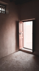 A door from inside an abandoned house in Aljazeera Alhamra old town in Ras Al Khaimah, the United Arab Emirates.
