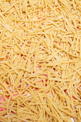 Homemade pasta made from wholesome whole wheat flour on a kitchen cloth.