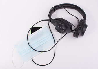 Medical mask of protection against contamination. headphones and cell phone health And medical...