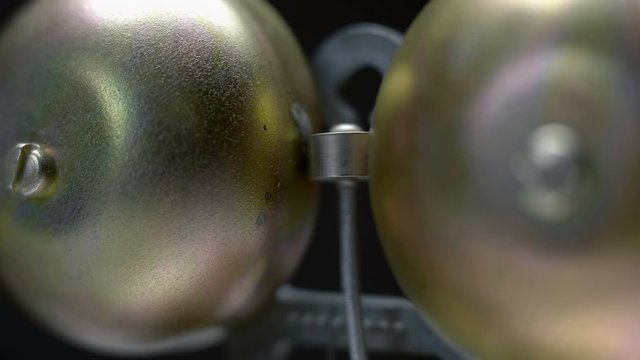A metal electric bell that is used in school to start break, to signal alarms and in to industry. Includes audio. Contains audio. Macro. Closeup. Shallow depth of field