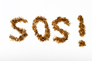 The inscription "SOS!" from tobacco for cigarettes on a white background, the harm of Smoking.