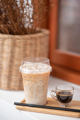 Iced coffee in a clear glass that can see the ice inside the glass And was placed in a coffee shop
