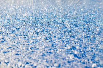 Obraz premium Hoarfrost on the surface. Background. Copy space. Close-up. Toned in blue