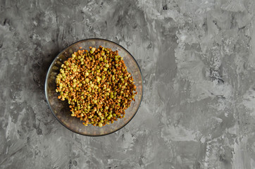 lentils in a transparent bowl on a grey background