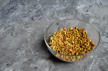 lentils in a transparent bowl on a grey background