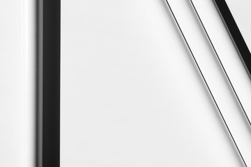 White tubes arranged in geometric, regular lines. Modern background. White, grey and black. Copy space.