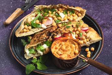 Healthy vegetarian tortilla or pita bread with chickpeas, vegetables and herbs served with homemade...