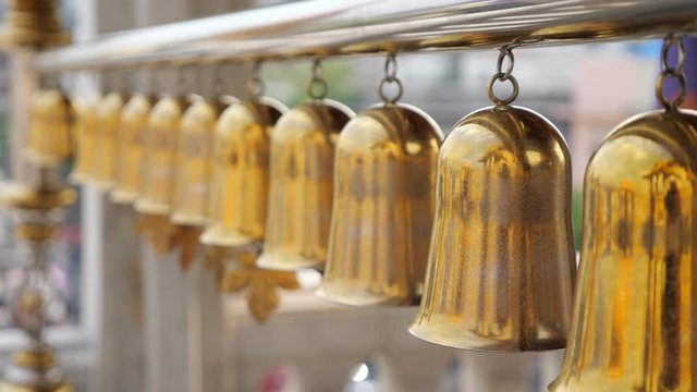 Buddhism. beautiful golden traditional Buddhist bells in Bangkok close-up