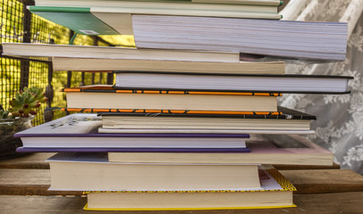 Fototapeta premium Stack of book of different sizes and color photographed from close up