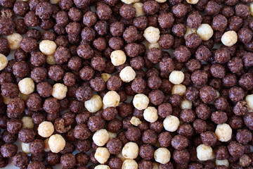  Cocoa and milk balls with sugar as background. Dry breakfast     