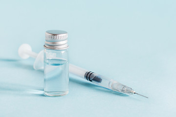 Medical glass vials and syringe for vaccination.