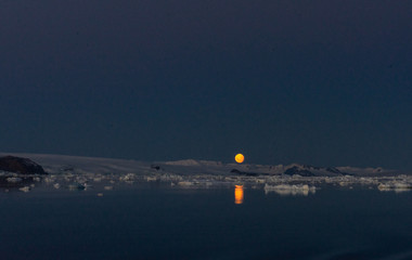 Naklejka na ściany i meble moon over the sea in Antarctica