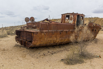 Fototapeta na wymiar Rusty ship at the ship cemetery in former Aral sea port town Moynaq (Mo‘ynoq or Muynak), Uzbekistan