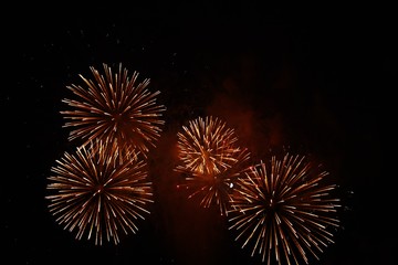 Red and orange fireworks in the night sky for a celebration
